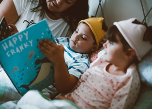Ending your child's bedtime routine by reading a book promotes early literacy skills. Plus, incorporating time with books into a stay at home schedule can provide variety and moments for connection.