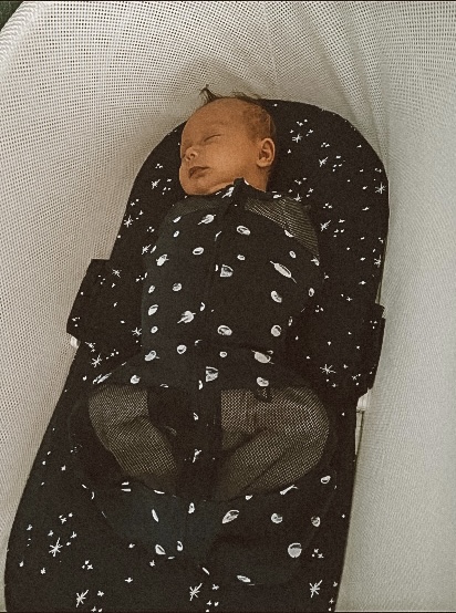 This baby is secured into place using the Snoo's built-in swaddle feature.