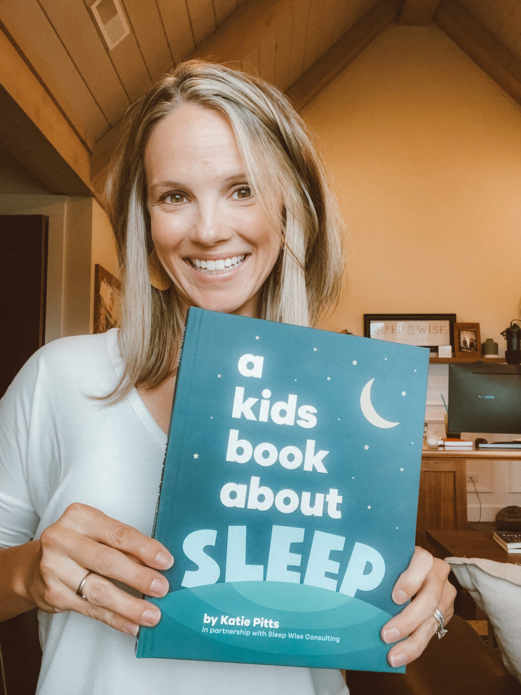 Author of 'A Kids Book About Sleep' shows off a copy of her children's book. 
