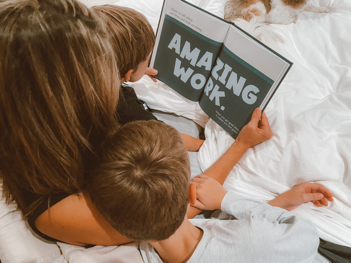 Author of 'A Kids Book About Sleep' pictured reading her book with her children. Not only does reading with your children promote early literacy skills, but this book aims to empower kids to feel good about healthy sleep habits.